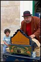 Barrel organ player and kid. Quartier Latin, Paris, France (color)