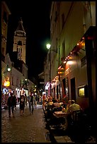 Dinners and narrow pedestrian street at night, Montmartre. Paris, France