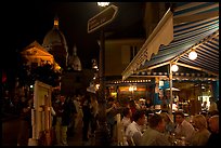 Outdoor dining at night on the Place du Tertre, Montmartre. Paris, France