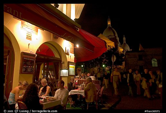 Outdoor restaurant at night on the Place du Tertre, Montmartre. Paris, France