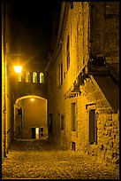 Cobblestone street by night inside medieval city. Carcassonne, France (color)