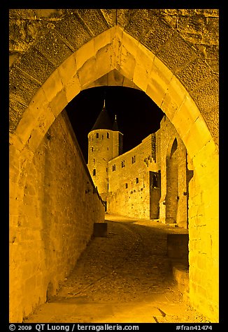 Ramparts and tower framed by gate at night. Carcassonne, France (color)