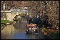 Tranquil scene with barge, bridge, and trees, Canal du Midi. Carcassonne, France ( color)