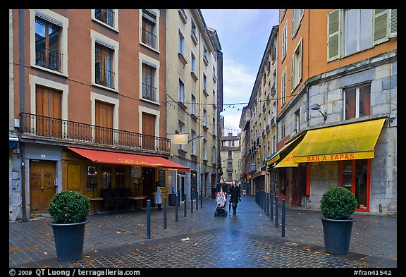 Pedestrian street with couple pushing stroller. Grenoble, France