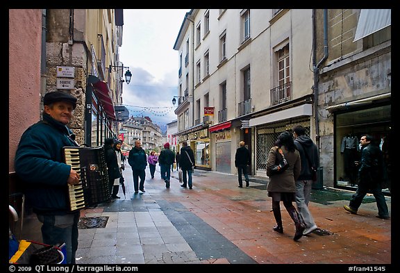 Accordeon musician on commercial pedestrian street. Grenoble, France (color)
