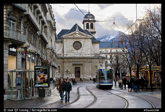 Street with people walking, tramway and church. Grenoble, France (color)