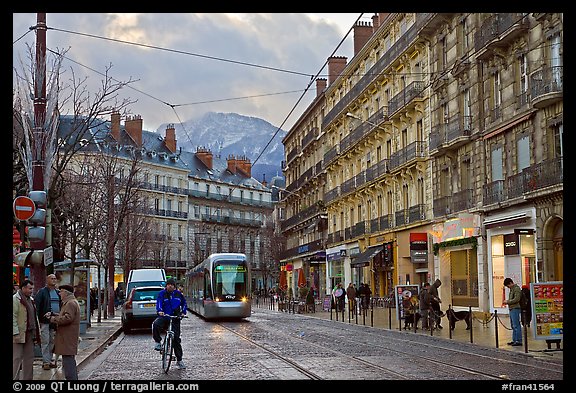 Bicyclist and tramway next to Victor Hugo place. Grenoble, France (color)