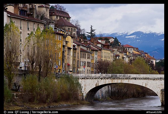 Stone bridge, houses, and snowy mountains. Grenoble, France (color)