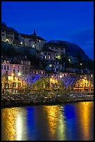 Hillside houses and Christmas lights reflected in Isere River. Grenoble, France (color)