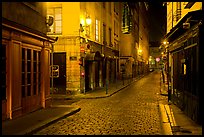 Narrow cobblestone street in historic district at night. Lyon, France
