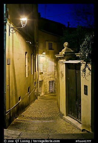 Narrow cobblestone street and street light. Avignon, Provence, France