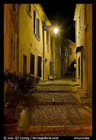 Cobblestone passageway with stepts at night. Arles, Provence, France