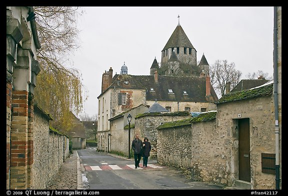 Street with couple walking and Caesar's Tower in background, Provins. France