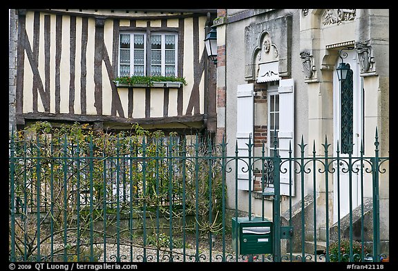 Fence, stone house, and half-timbered house, Provins. France (color)