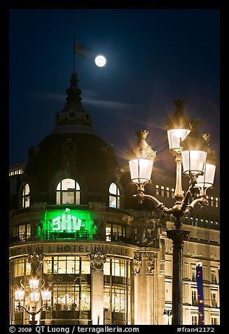Street lamps, BHV department store, and moon. Paris, France