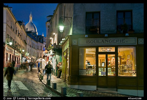 Bakery, street and dome of Sacre-Coeur at twilight, Montmartre. Paris, France