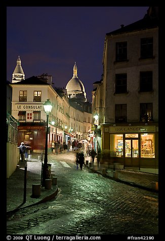 Street and Sacre-Coeur dome at night, Montmartre. Paris, France