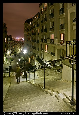 Woman on stairs by night, Montmartre. Paris, France