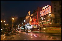 Boulevard by night with Moulin Rouge. Paris, France
