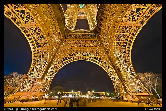 Eiffel Tower pilars from below and Ecole Militaire at night. Paris, France (color)