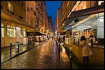 Woman buying food on street at night. Quartier Latin, Paris, France ( color)