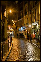 Cobblestone street with restaurants by night. Quartier Latin, Paris, France ( color)