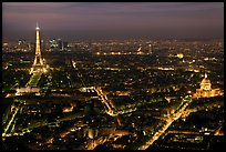 Aerial view at night with Eiffel Tower, Invalides, and Arc de Triomphe. Paris, France