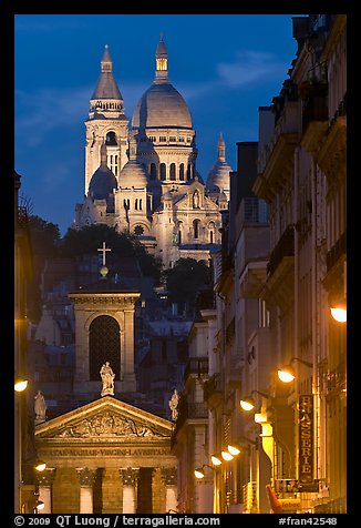 Church of Notre-Dame-de-Lorette with the Basilica of the Sacre Coeur behind at night. Paris, France (color)