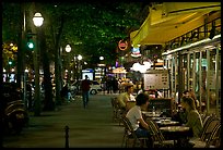 Outdoor cafe terrace on the Grands Boulevards at night. Paris, France