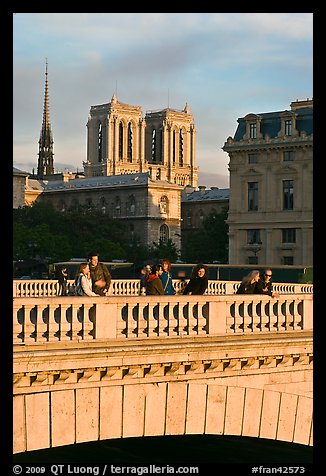 Watching the sunset from a bridge, with Notre Dame towers behind. Paris, France (color)