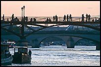 Seine river and people silhouettes on Pont des Arts. Paris, France