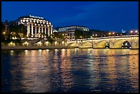 Pont Neuf and Samaritaine reflected in Seine River at night. Paris, France