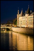 Conciergerie reflected in Seine river at night. Paris, France