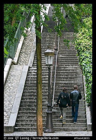 Couple walking up steet stairs, Montmartre. Paris, France (color)