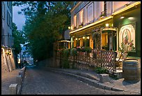 Cobblestone street and restaurant at dusk, Montmartre. Paris, France (color)