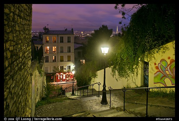 Hillside stairs of butte Montmartre and street lights at sunset. Paris, France (color)