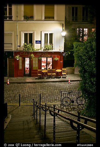 Hillside stairs on butte, street and restaurant at night, Montmartre. Paris, France (color)