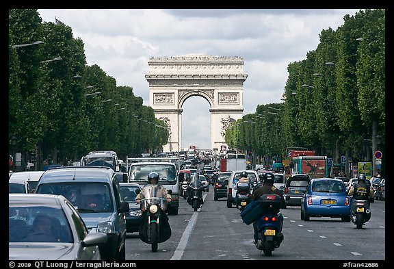 Car and motorcycle traffic and Arc de Triomphe, Champs-Elysees. Paris, France (color)