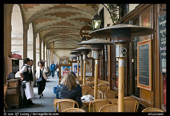 Outdoor cafe tables and heating lamps, place des Vosges. Paris, France