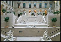 Ancient sculptures in display in Louvre Museum room. Paris, France
