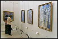 Tourists looking at Monet's Rouen Cathedral, Orsay Museum. Paris, France