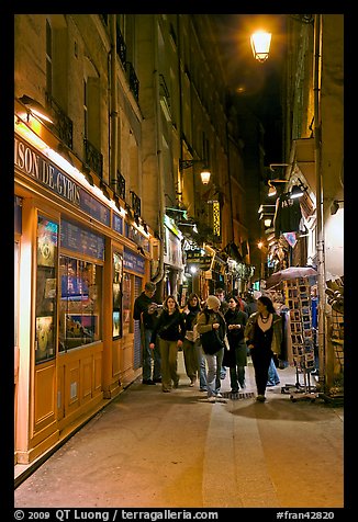 People walking in pedestrian street at night. Quartier Latin, Paris, France