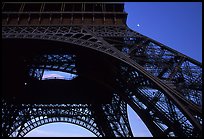 Base of Tour Eiffel (Eiffel Tower) with moon. Paris, France