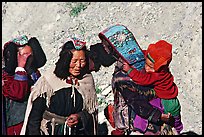 Elderly women with turquoise-covered head adornments, Zanskar, Jammu and Kashmir. India (color)
