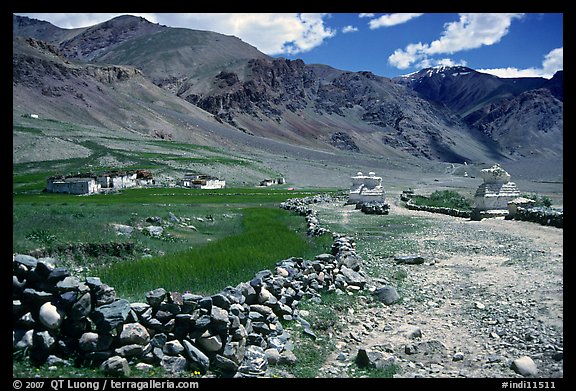 Stone fence, chortens, cultivations, and village, Zanskar, Jammu and Kashmir. India