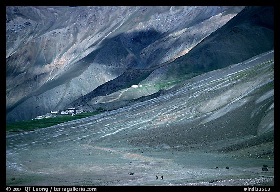 Barren hills with figures walking towards Karsha monastery, Zanskar, Jammu and Kashmir. India (color)