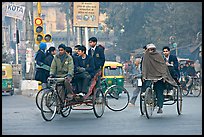 Cycle-rickshaws carrying uniformed schoolchildren. New Delhi, India (color)