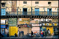 Street with old buildings and storefronts closed, Old Delhi. New Delhi, India ( color)