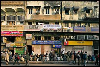 Street with many people waiting in front of closed stores, Old Delhi. New Delhi, India ( color)