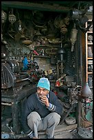 Man sitting in front of machine parts shop, Old Delhi. New Delhi, India (color)
